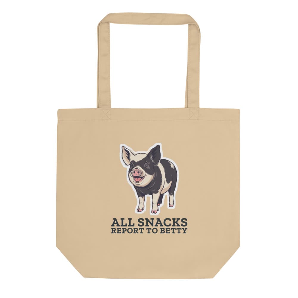 Canvas tote printed with cartoon Betty the pig and the words all snacks report to Betty.